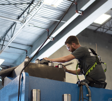 man working to build a piece of machinery