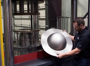 beckwood engineer placing a part to be formed on a hydraulic deep draw